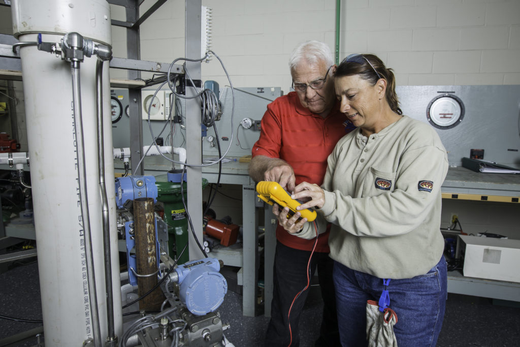 INSTRUMENT OF CHANGE: Level 4 instrument and electrical instructor Jay Lockwood works with student Jennifer Clark on a small-scale process control loop. Clark, 42, is studying instrumentation at Associated Builders and Contractors – Pelican Chapter in Baton Rouge to advance her career. (Photo by Tim Mueller)